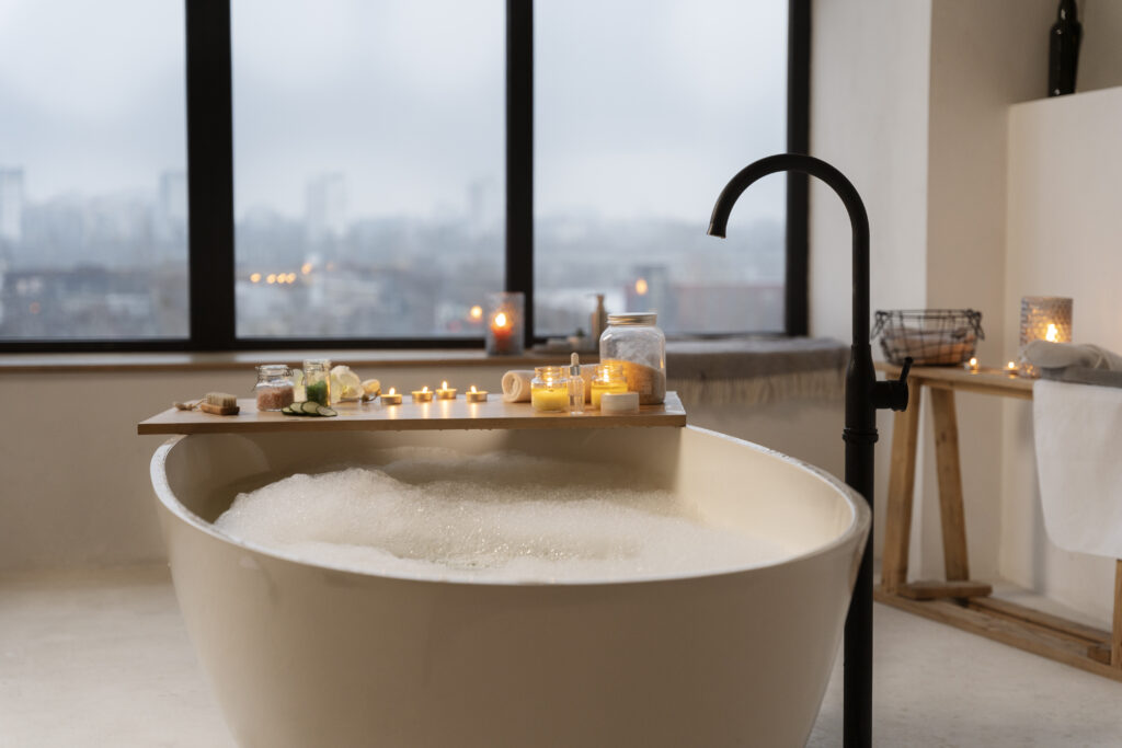 bathroom with candles bathtub filled with water for bathing